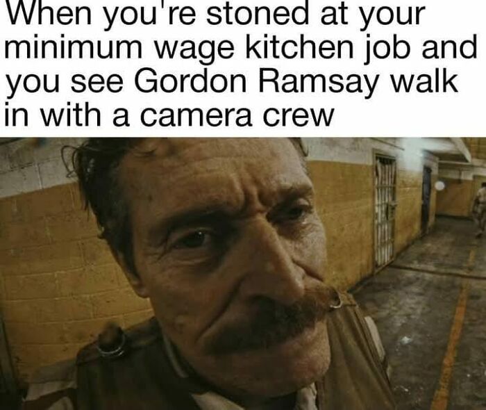 Man with mustache in a dimly lit hallway showing a relatable hospitality work meme about kitchen jobs and camera crews.