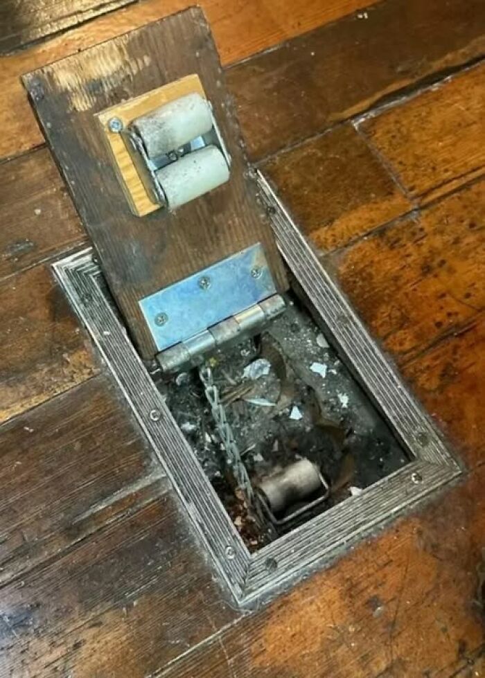 Hidden floor compartment with old rollers and chains found in homes with haunted pasts and strange history.