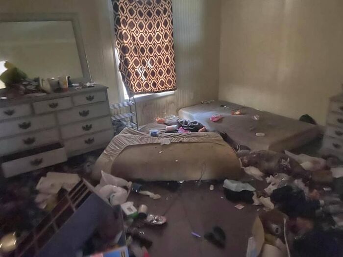 Cluttered and dirty bedroom with stained mattresses and scattered trash, illustrating worst real estate photos ever.