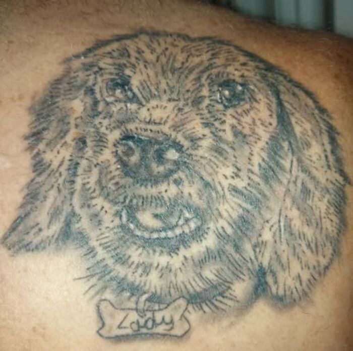 Tattoo of a dog with a name tag on skin, an example of people getting inked to look cool but with a permanent mistake.