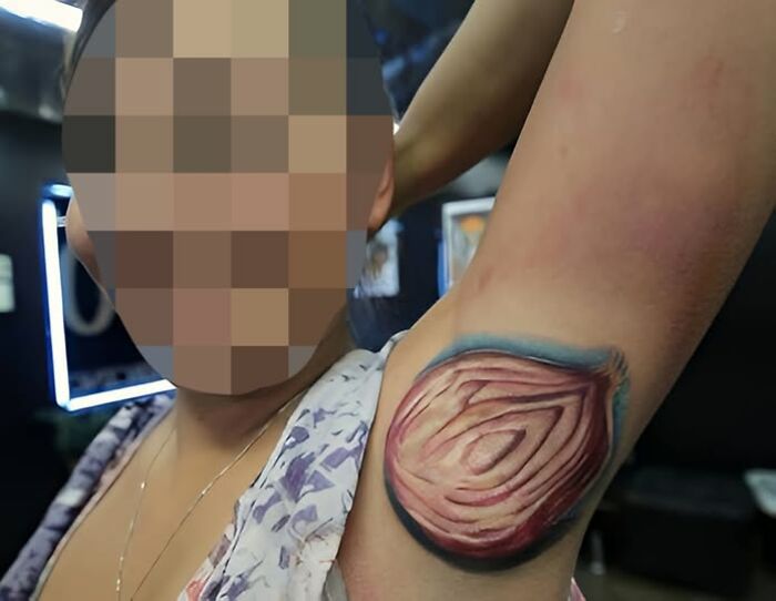 Person showing a detailed, realistic onion tattoo on their armpit, an example of inked mistakes meant to look cool.