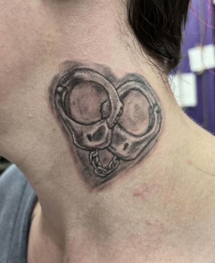 Handcuff tattoo on neck with shading detail, an example of inked designs that turned into a permanent mistake.