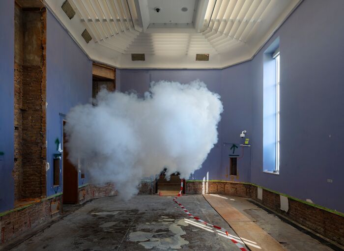 Indoor space with realistic clouds created using a combination of smoke and water vapor art installation.