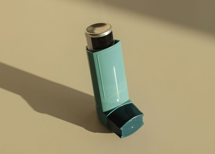 Inhaler casting a long shadow on beige surface illustrating bosses teachers or parents going off the rails.