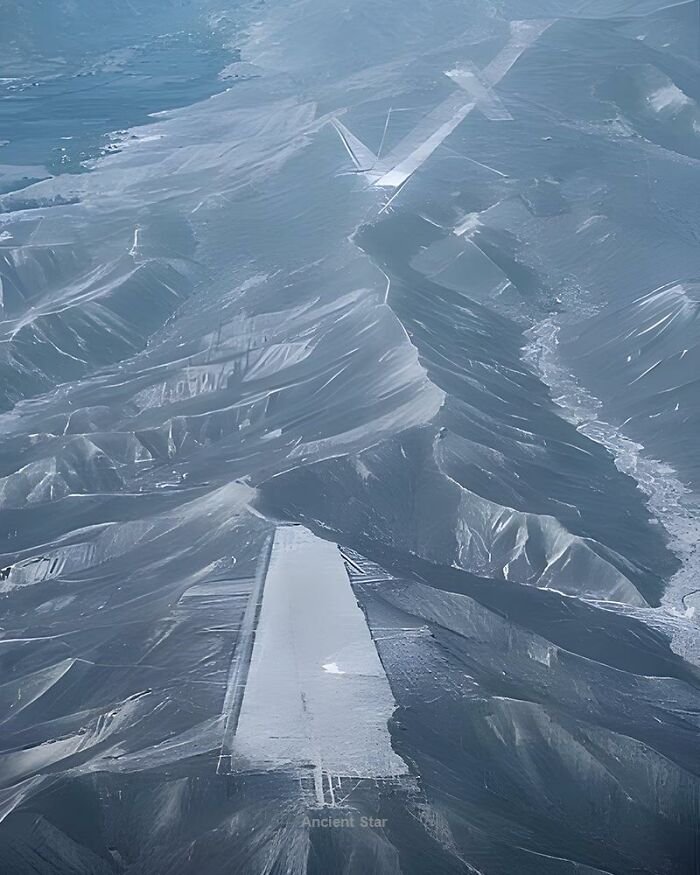 Aerial view of mysterious ancient geoglyphs carved into rugged terrain, highlighting fascinating ancient history.