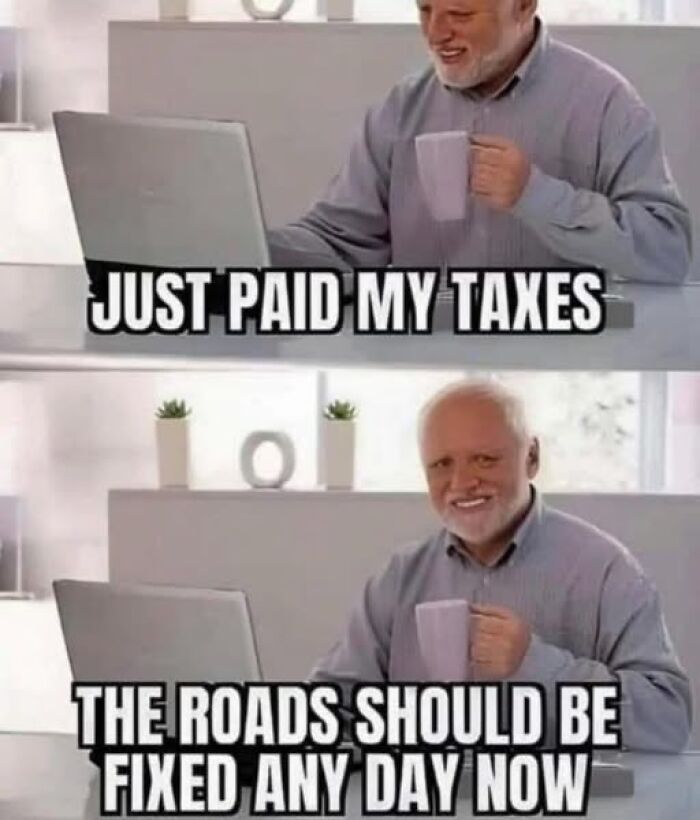 Elderly man smiling at laptop with mug, meme about paying taxes and expecting road repairs, vegan meme humor.
