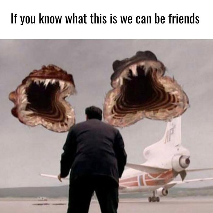 Man standing near airplane with two giant mouth-like creatures in the sky, evoking nostalgic memories and childhood fears.