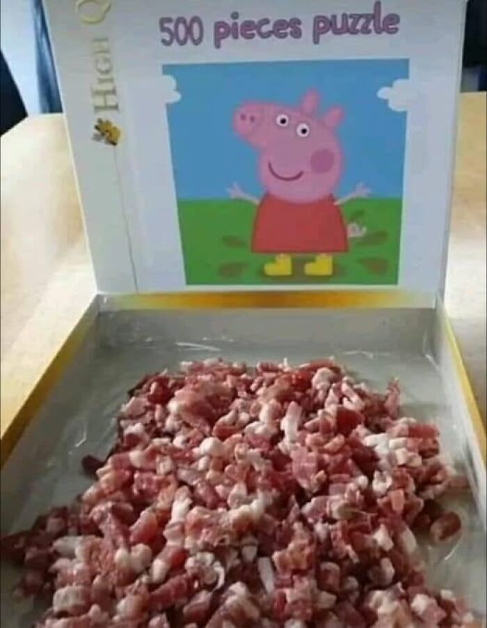 Puzzle box showing cartoon pig with 500 pieces replaced by raw meat pieces in a meme about veganism humor.