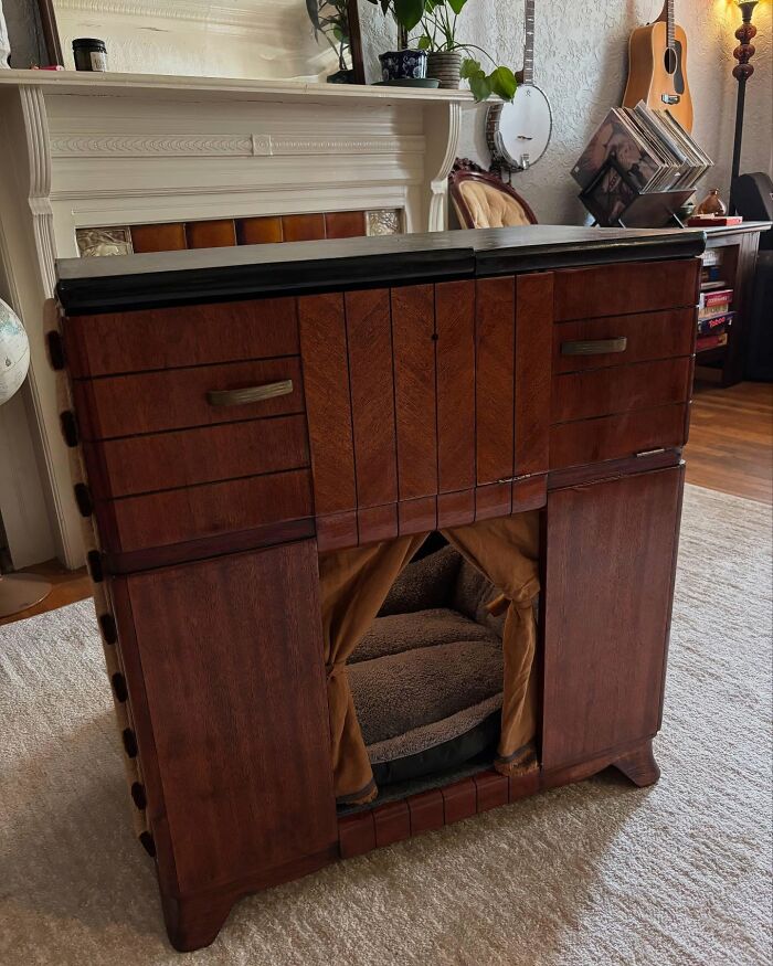 Vintage TV repurposed into a cozy cat bed with warm wood tones, blending nostalgic nooks and creative pet furniture design.