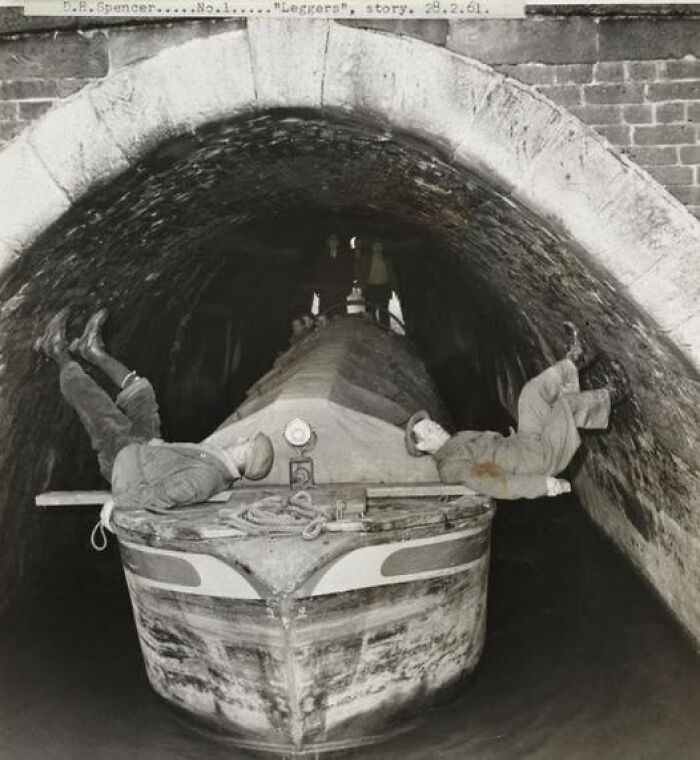 Men working on a narrowboat inside a tunnel, showcasing antique historical photographs of past labor and transportation methods.