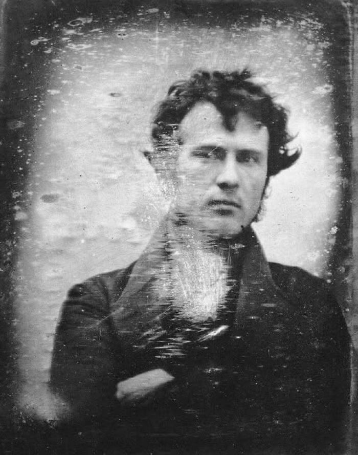 Antique historical photograph of a man with dark hair wearing a coat, displaying early photography techniques and aged texture.