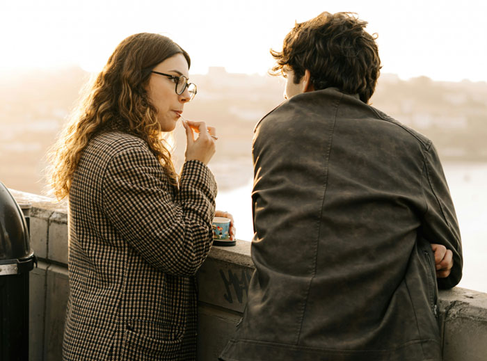 Young woman and her boyfriend having serious talk outdoors during sunset, discussing relationship and future plans. Young woman and her boyfriend having serious talk outdoors during sunset, discussing relationship and future plans.