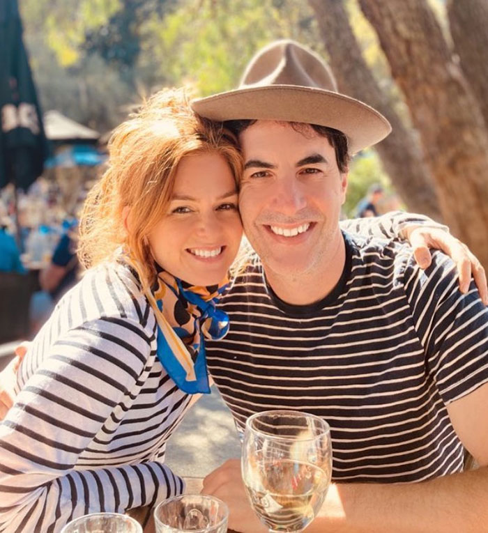 Isla Fisher and Sacha Baron Cohen smiling together outdoors amid growing tension in their $119 million divorce. Isla Fisher and Sacha Baron Cohen smiling together outdoors amid growing tension in their $119 million divorce.