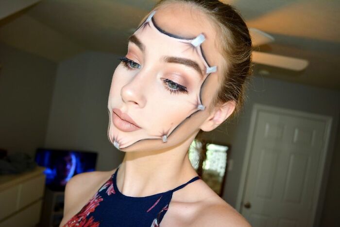Woman with creative makeup illusion showing a peeling face effect, showcasing stunning makeup looks by talented artists.