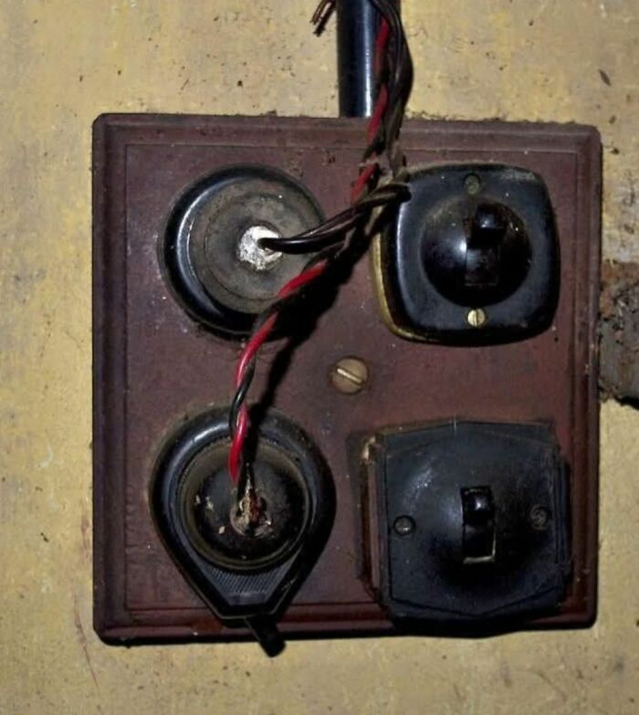 Old electrical switchboard with exposed wiring found in homes with hidden or haunted pasts.