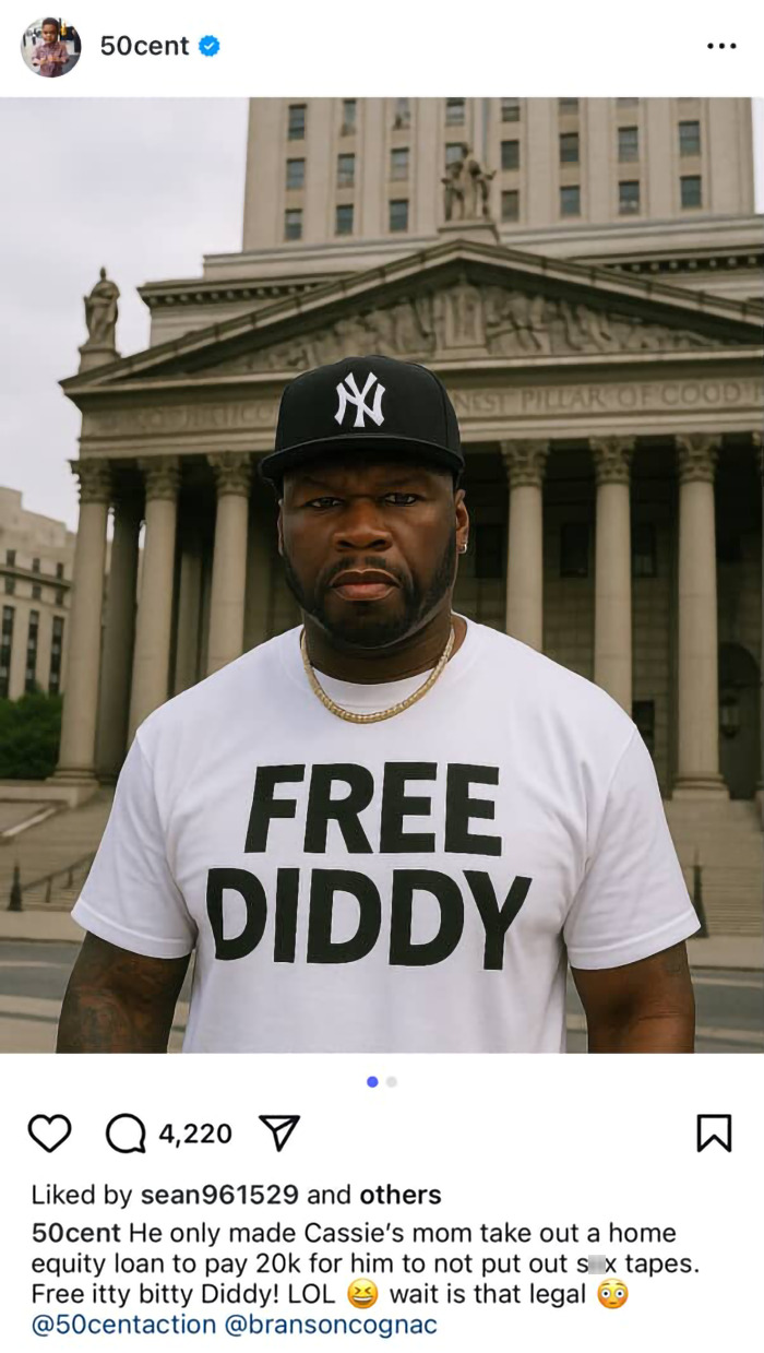 50 Cent wearing a Free Diddy shirt and New York Yankees cap in front of a classical building with columns.