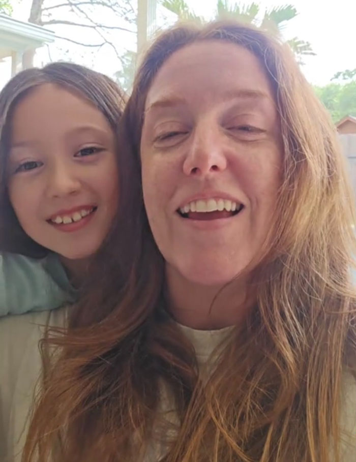 Mom smiling with her child outdoors, sharing a moment after petty revenge leads to family packing for themselves and going viral