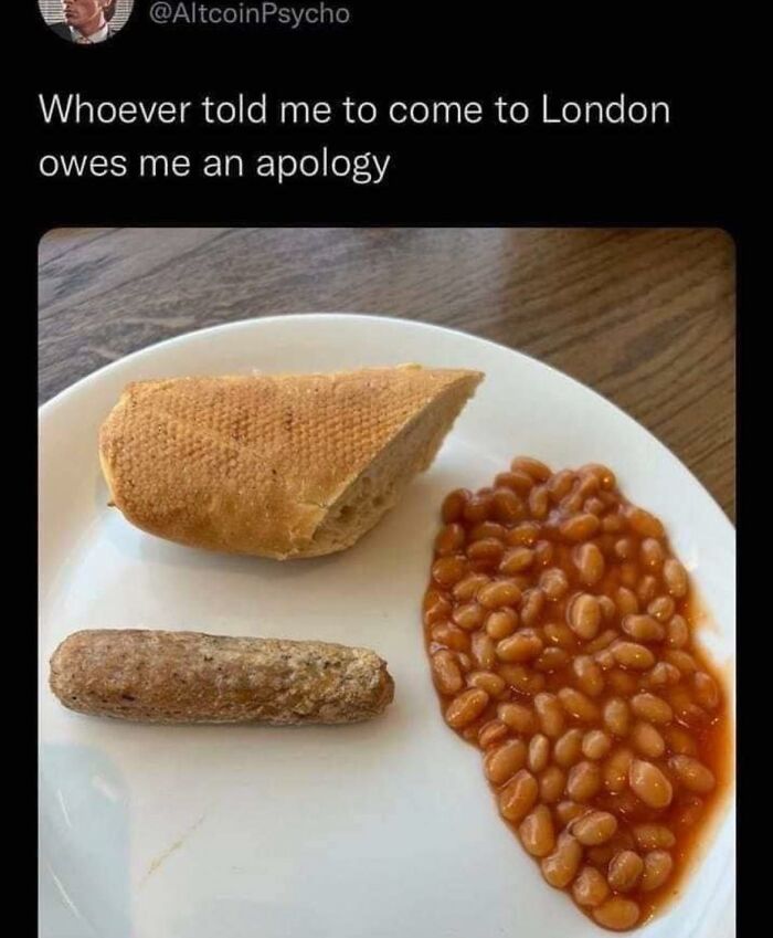 Plate with a small sausage, baked beans, and a bread piece, humorously referencing funny memes about tough days.