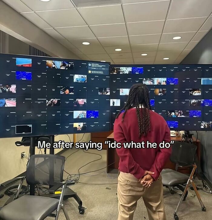 Person standing in front of multiple large screens displaying various images, illustrating cute and wholesome posts.