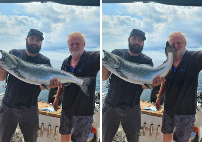 Two men holding a large fish on a boat with a hilarious Photoshop edit showing the fish’s tail hitting one man’s face.