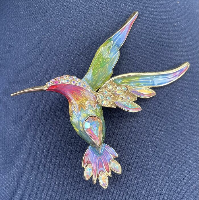 Colorful hummingbird brooch with iridescent stones, a unique thrifted find that belongs in a museum for being so wonderful and weird