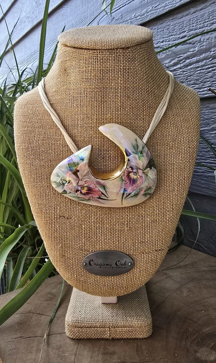 Abstract floral necklace displayed on a burlap stand, one of the thrifted finds with a unique and wonderful design.