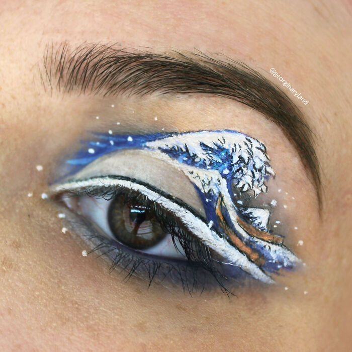 Eye makeup featuring a detailed wave design with blue and white colors showcasing incredible makeup looks by talented artists.