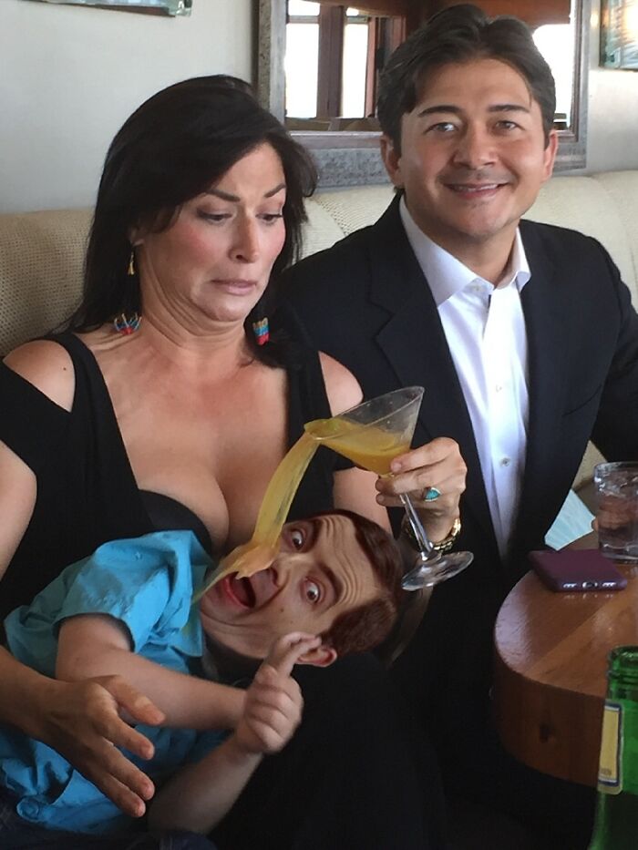 Woman spilling drink humorously edited to pour over a man’s face, showcasing hilarious Photoshop skills with two people at a table.