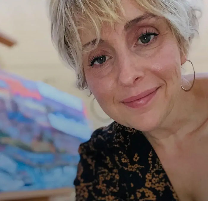 Close-up of a woman with short blonde hair and hoop earrings, related to Hallmark actor tears after Vancouver attack.