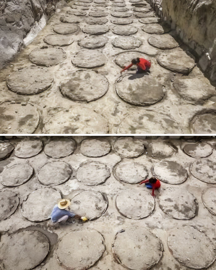 Archaeologists carefully excavating large circular ancient structures at a historic site during an archaeology dig.