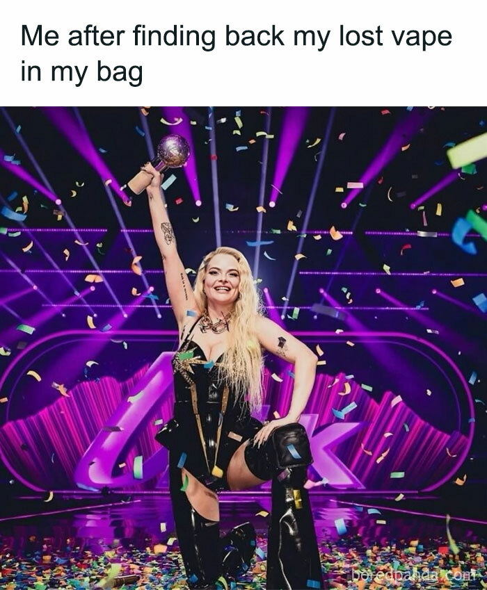 Woman celebrating on stage holding a trophy amidst confetti, capturing hilarious memes from the 2025 Eurovision Song Contest.
