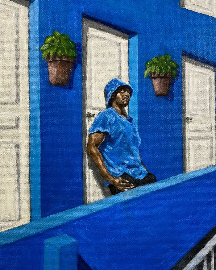 Man in blue shirt and hat leaning against a blue wall with white doors and potted plants in a painting exploring colours and space.