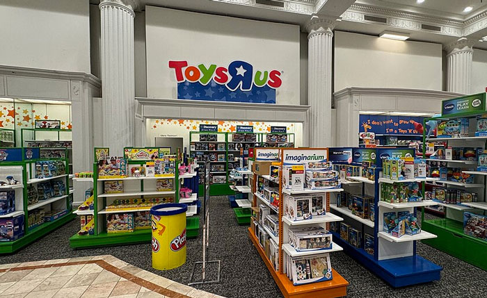 Toys R Us store interior with colorful toy displays and shelves, illustrating former employees revealing workplace secrets.