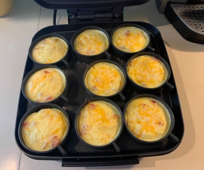 Muffin tin with freshly baked egg and cheese cups, a healthy breakfast hack for becoming a morning person.