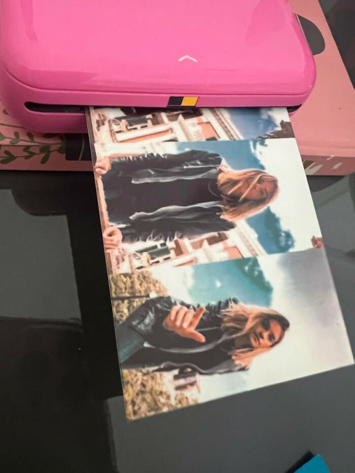 Compact pink photo printer printing a vibrant photo, showcasing popular Amazon tech finds and gadgets.