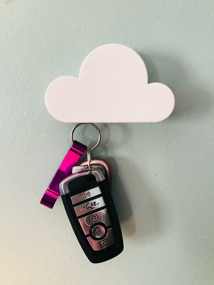 White cloud-shaped key holder on wall with car keys and a purple keychain hanging, symbolizing a mood lift.