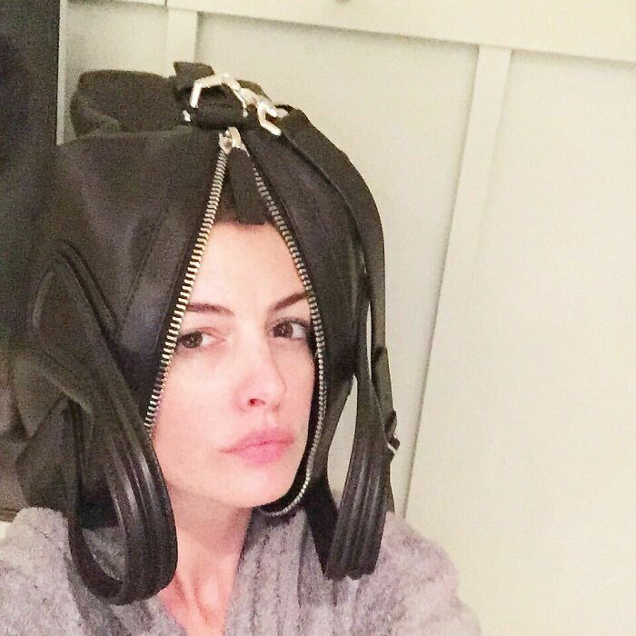 Celebrity selfie with a black leather bag worn on the head, showcasing creative Instagram posts shared way back in the day.