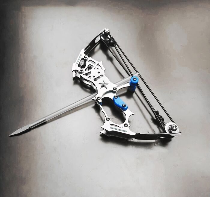 Crossbow-shaped office supplies tool with a unique metallic design and blue accents on a gray surface, creative desk accessory.
