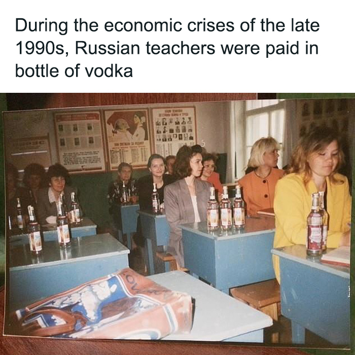 Russian teachers during the 1990s economic crisis sitting at desks with bottles of vodka in a historical moment frozen in time.