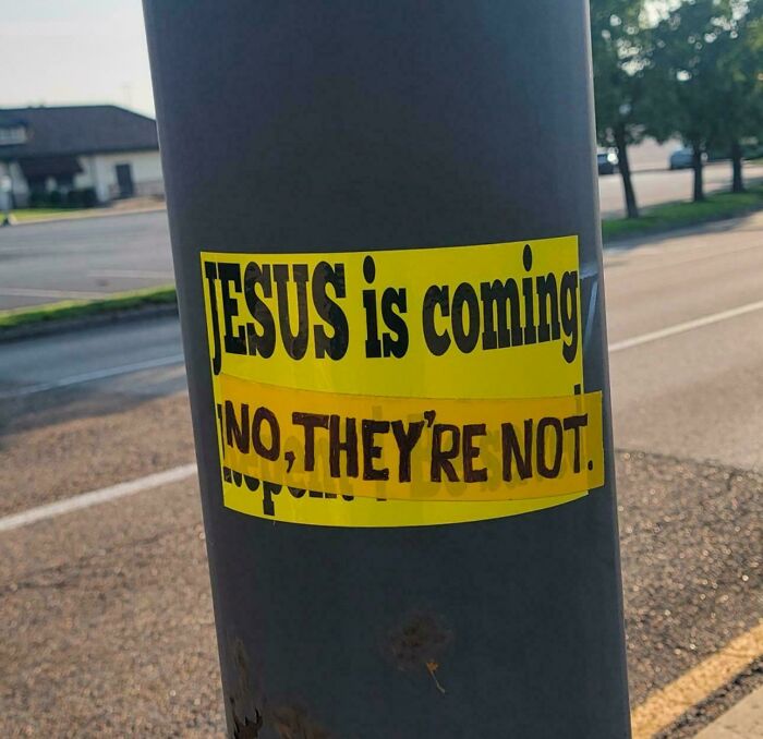 Sticker on a pole showing a playful message, an example of wholesome vandals making streets look and feel better.