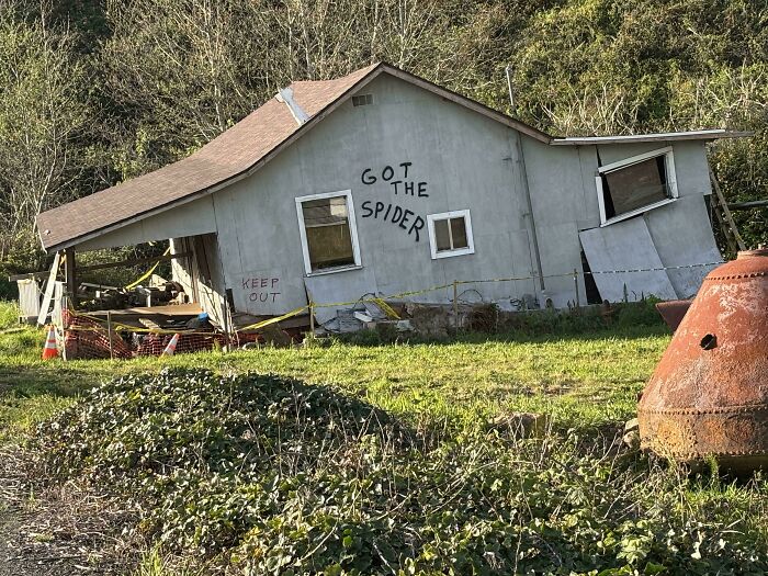 Dilapidated house with playful graffiti, an example of wholesome vandals improving urban street scenes.