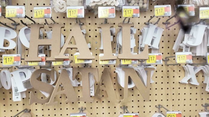 Wooden letters arranged on a pegboard, a creative example of wholesome vandals making streets look and feel better.