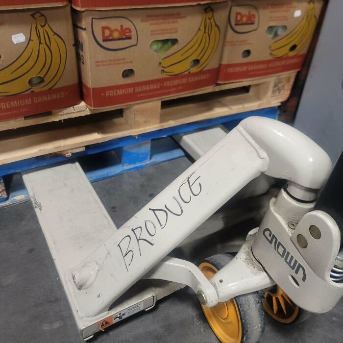 Handwritten word produce on a pallet jack wheel, showcasing wholesome street vandalism that improves urban spaces.