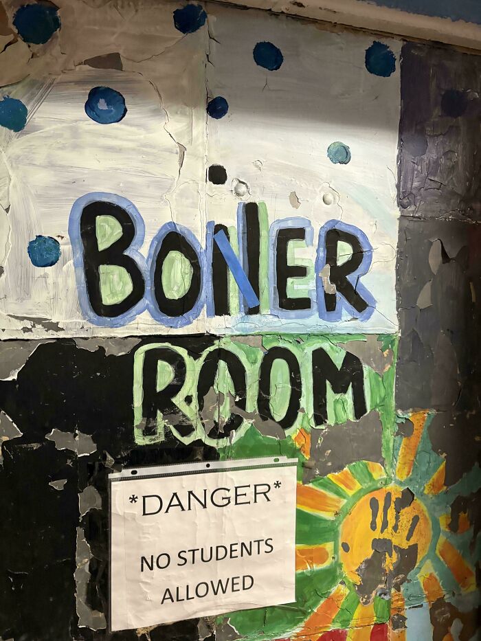 Graffiti art on a peeling wall with colorful letters and a warning sign, showcasing wholesome street vandal creativity.