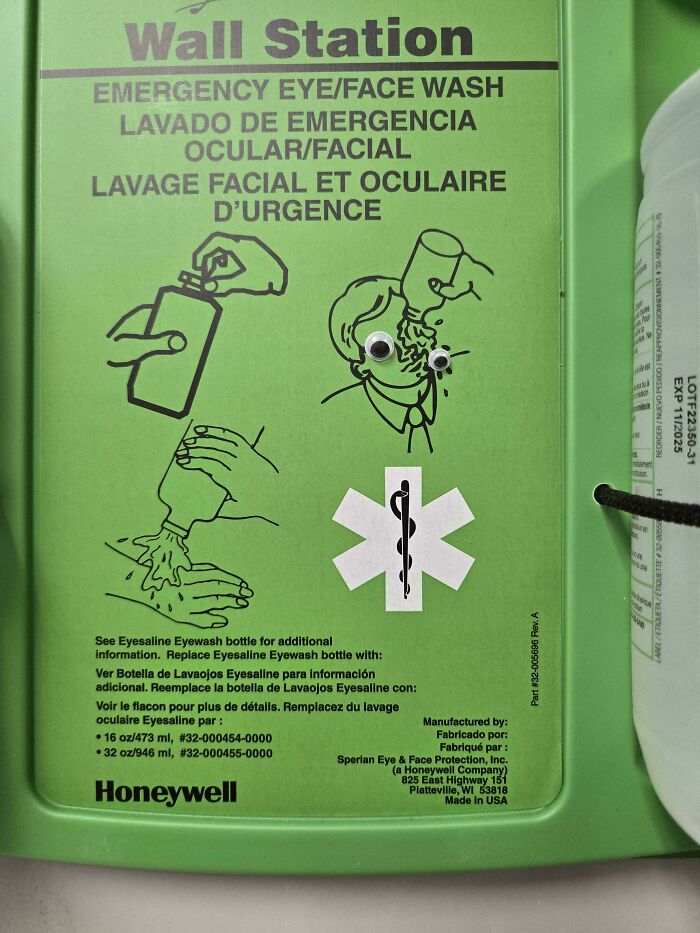 Emergency eyewash station with added googly eyes showing wholesome vandalism improving street safety equipment.