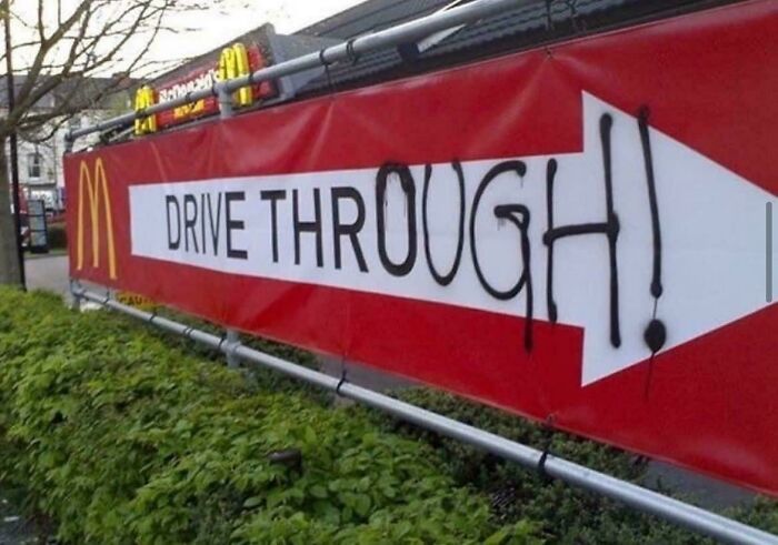 McDonald's drive-thru sign creatively altered by wholesome vandals to make streets look and feel much better.