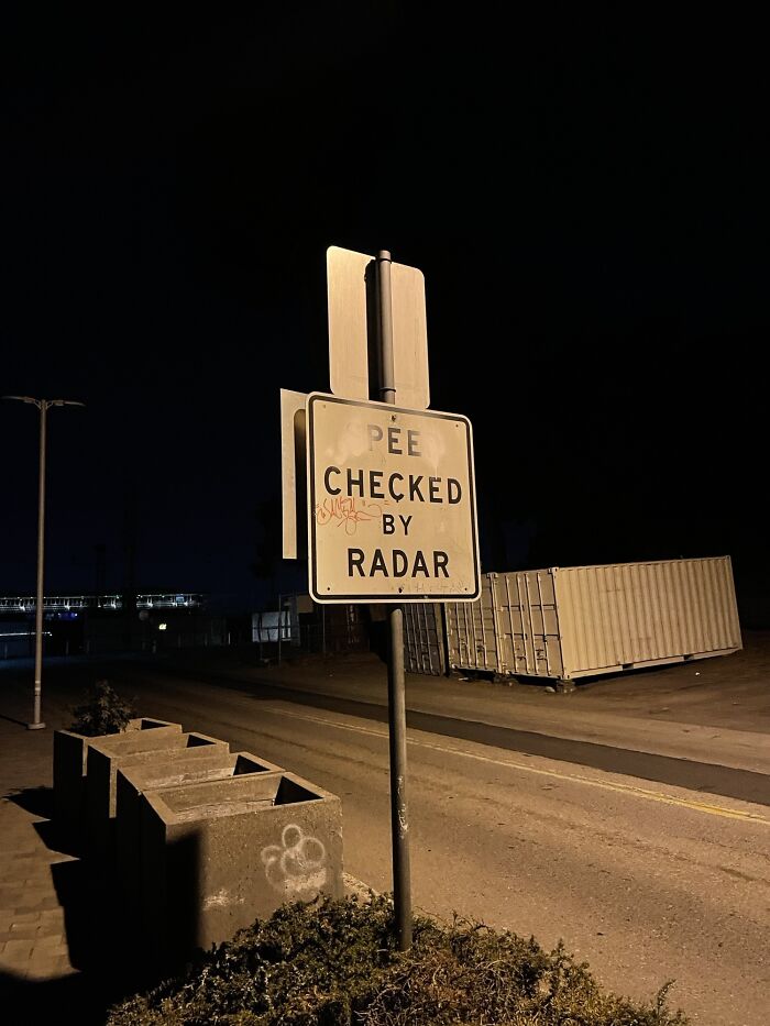 Street sign altered by wholesome vandals at night, adding humor to urban surroundings and improving the streetscape.