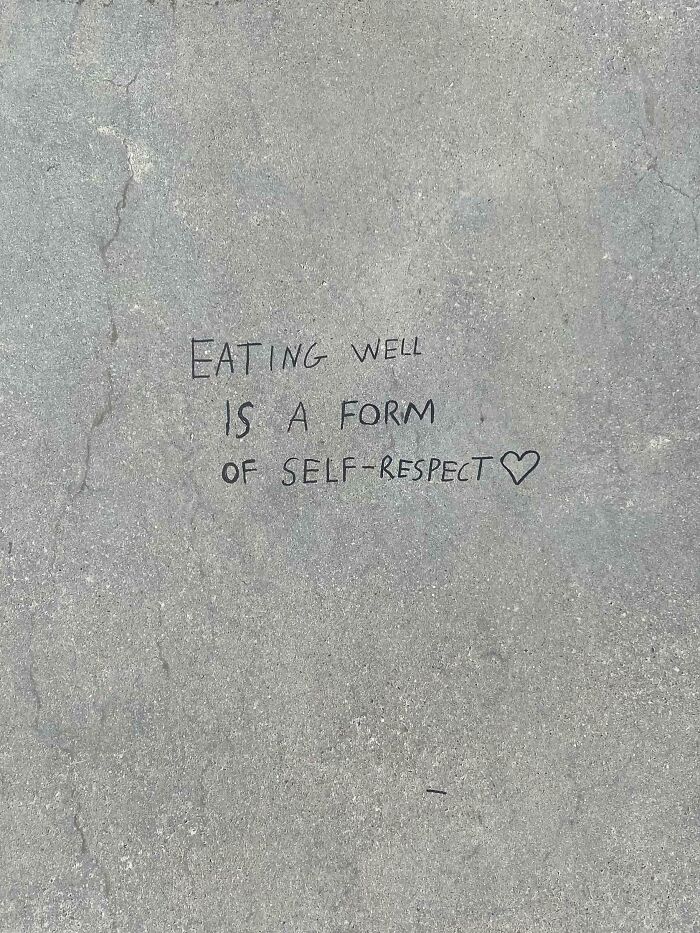 Positive street graffiti saying eating well is a form of self-respect, an example of wholesome vandals improving streets.