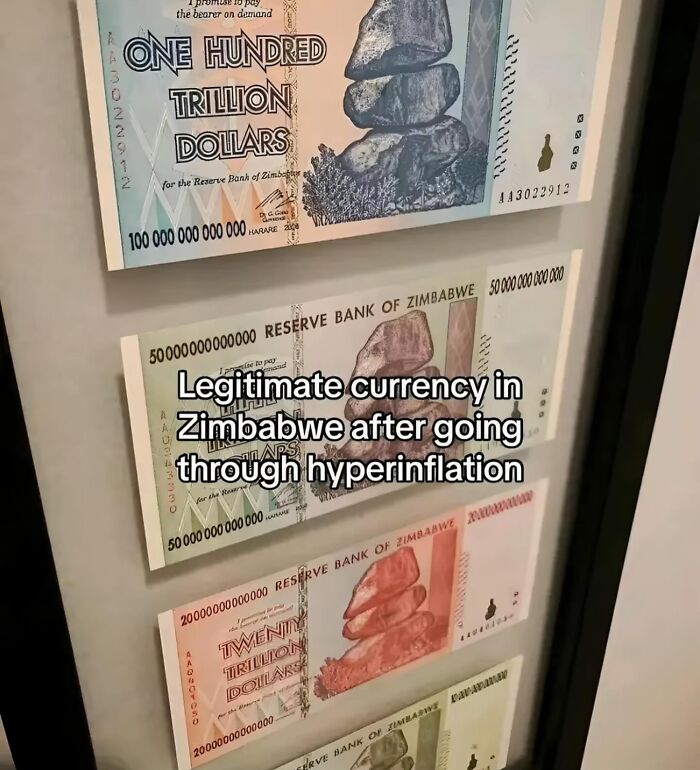 Framed Zimbabwe currency notes showing hyperinflation effects in a display related to the inside of Big Ben.