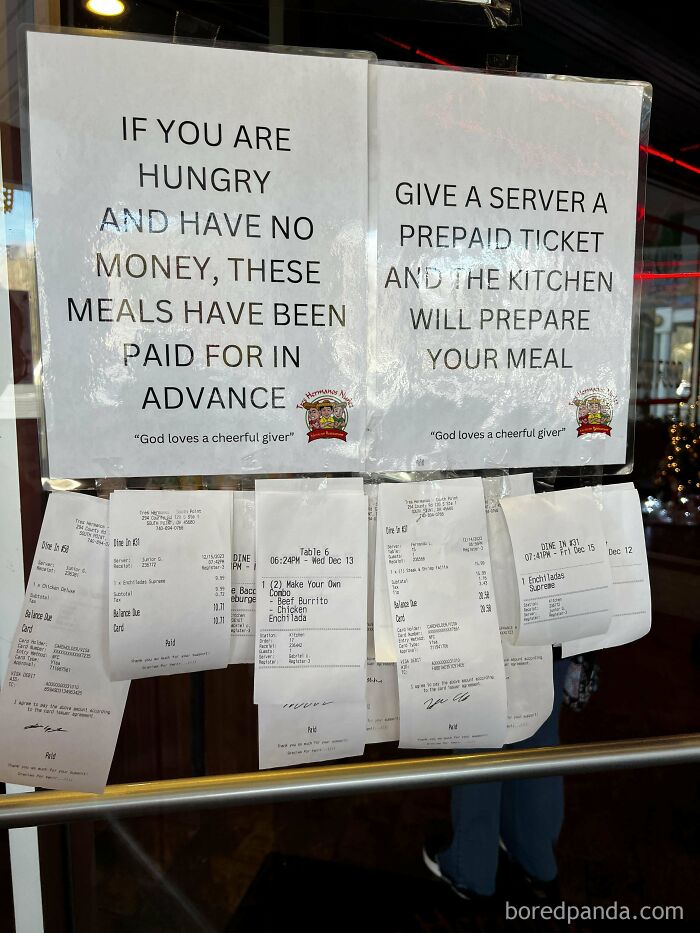 Sign at a restaurant window offering prepaid meals for those hungry without money, showing wholesome meme kindness.